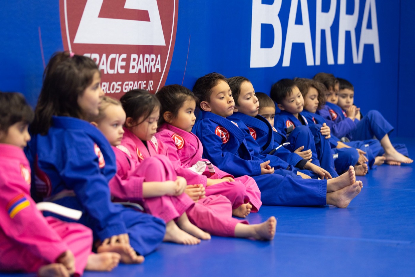 A row of young students sits focused on their instructor